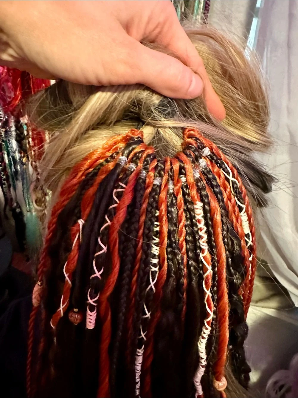Blonde Hair Extensions with Black and Orange Braided Accents